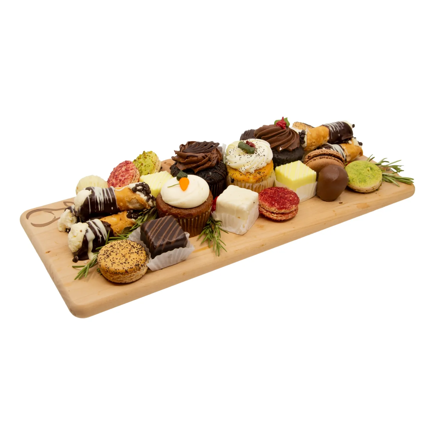 A wooden serving board piled with assorted pastries and desserts—cupcakes, chocolate-dipped treats, cookies, and cake squares—arranged with greenery, creating a festive, indulgent display.
