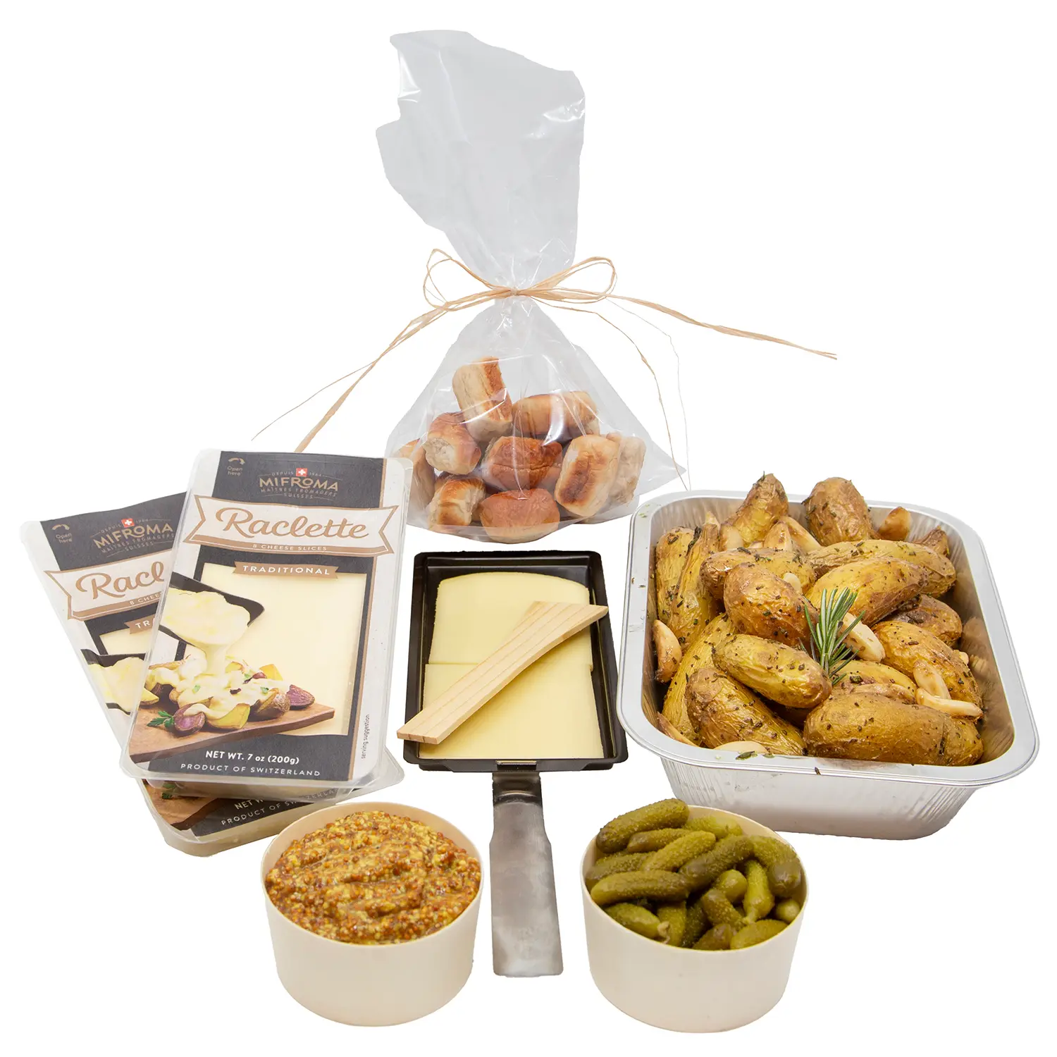 A festive raclette food gift set with melted-cheese packs, a cheese knife, bread rolls, roasted potatoes, pickles, and mustard.