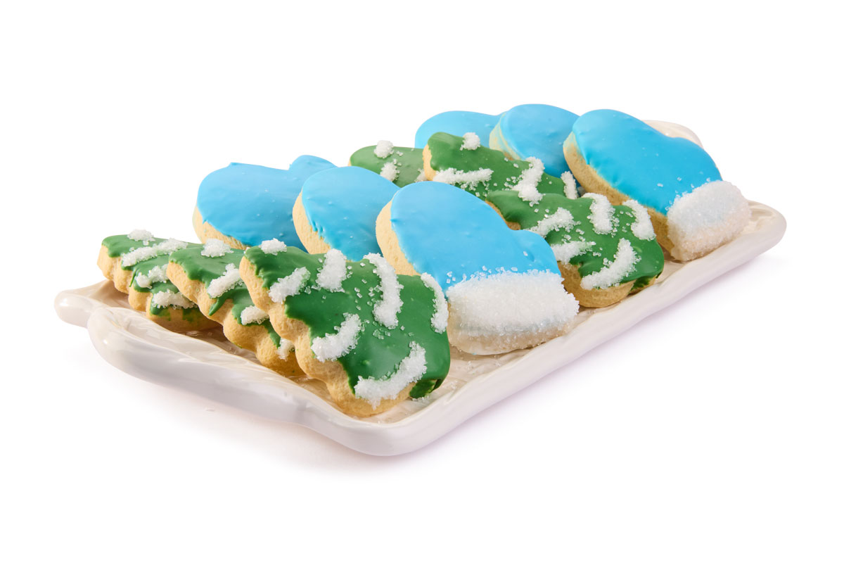 A cozy fall table setting featuring elegant dinnerware, patterned napkins, small pumpkins, pears, and glowing candles being lit for a warm, seasonal touch.