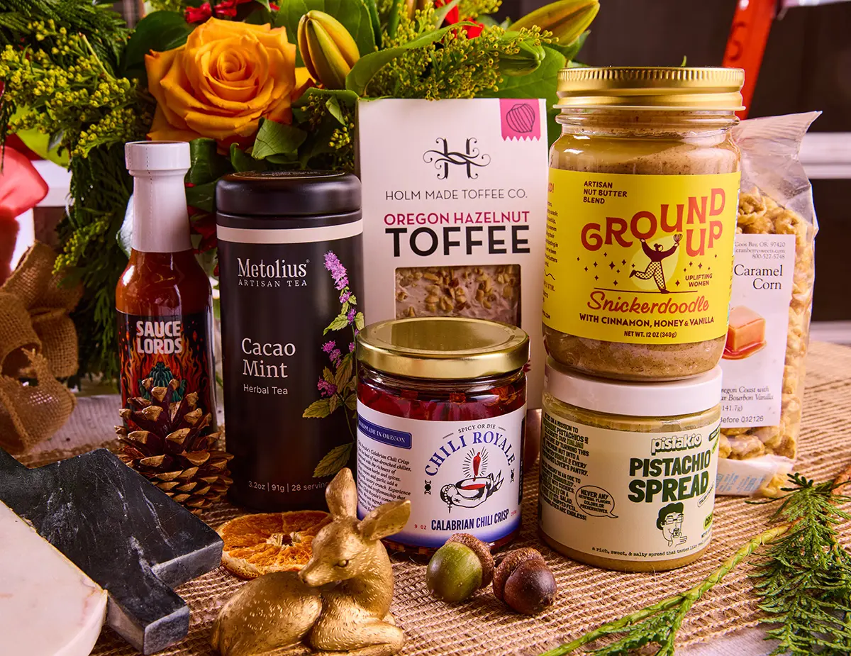 Oregon made products on a festive table display, including fresh flowers, tea, hot sauce, toffee, caramel corn and nut butters.